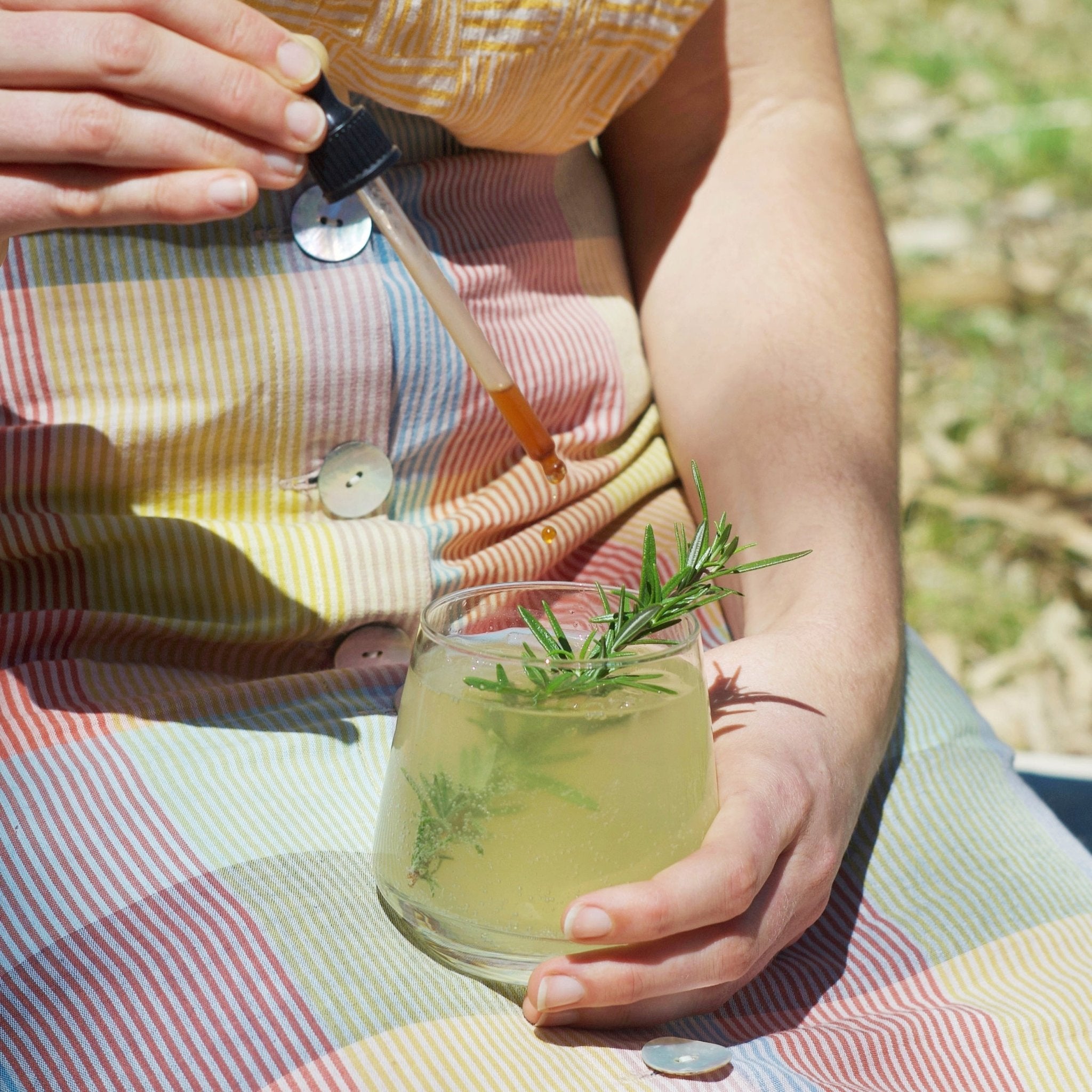 Aromatic Bitters dropping into a botanical lemon lime bitters