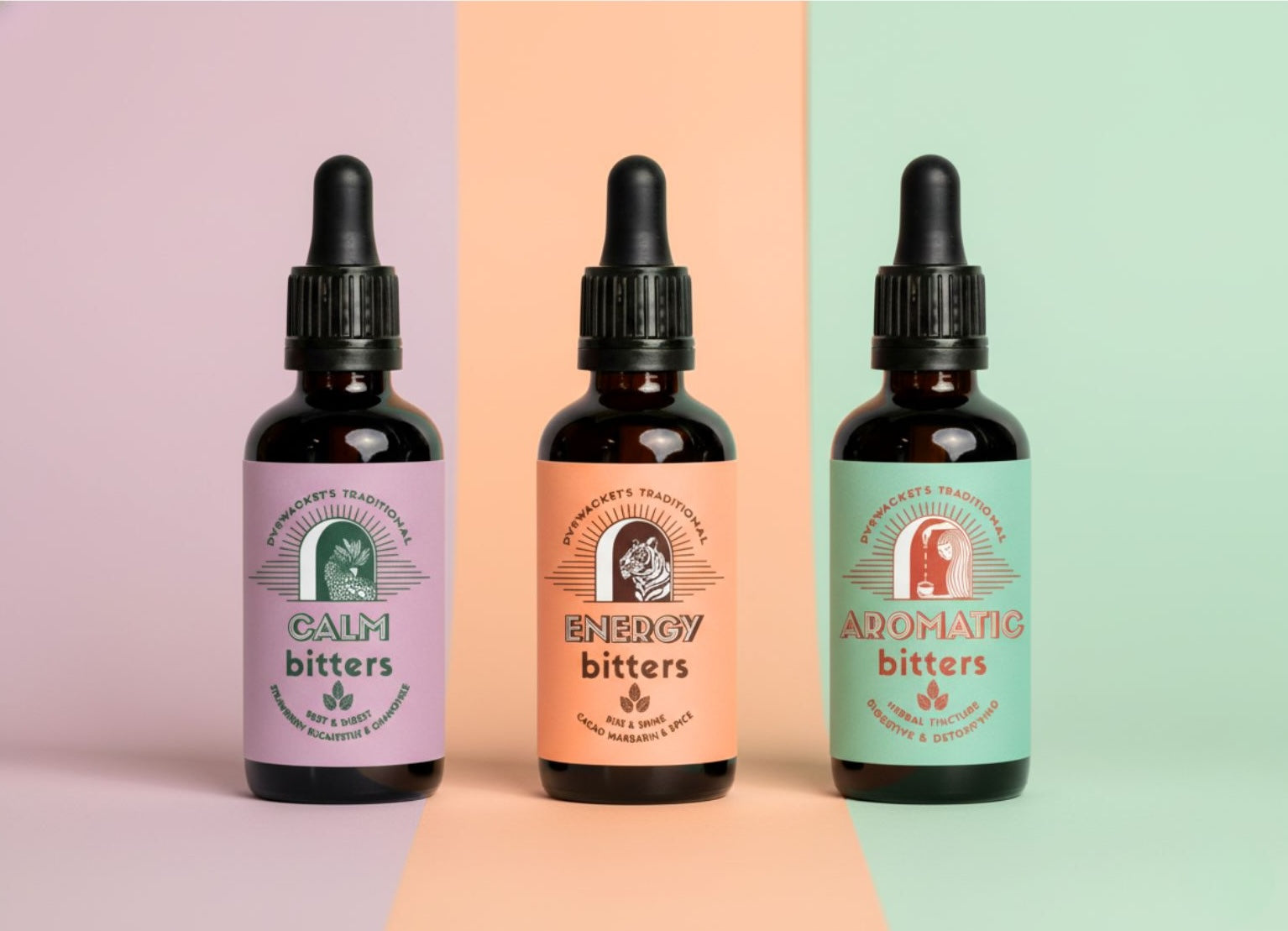 Three bottles of bitters with colorful labels on a multicolored background