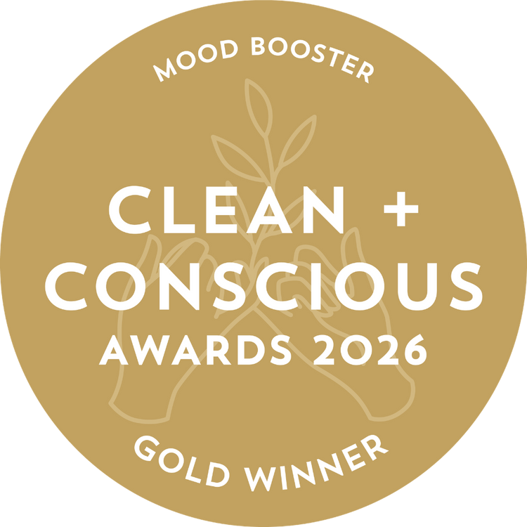 A circular gold badge with white text reading 'Mood Booster Clean + Conscious Awards 2026 Gold Winner' and a faint leaf illustration in the center, shown on a black background.