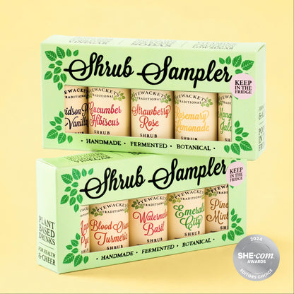 Two Shrub Sampler gift boxes shown on a pale yellow background. The boxes contain multiple small bottled shrubs with labels such as Cucumber Hibiscus, Strawberry Rose, Watermelon Basil, and Pineapple Mint.