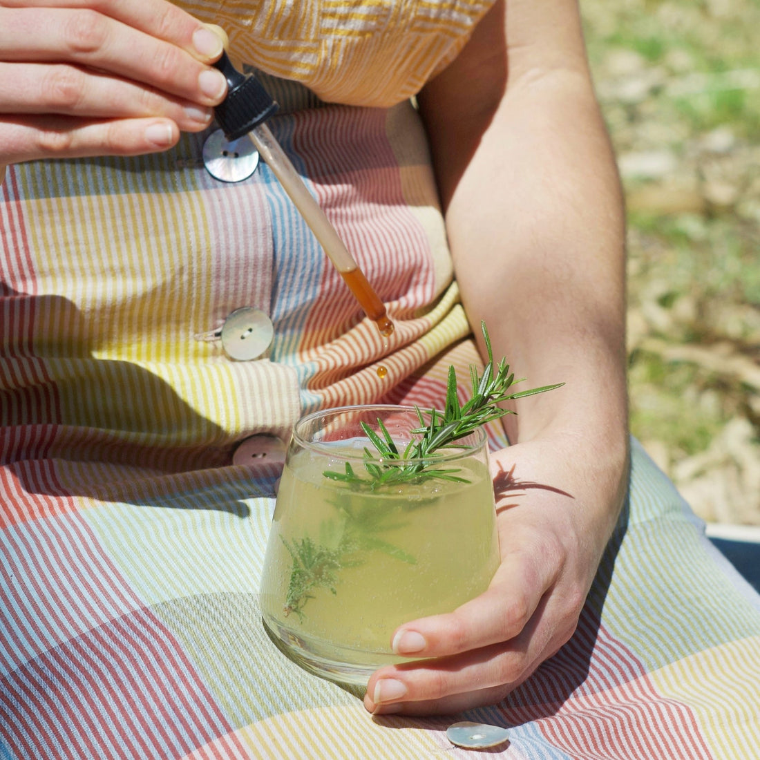 Aromatic Bitters dropping into a botanical lemon lime bitters 